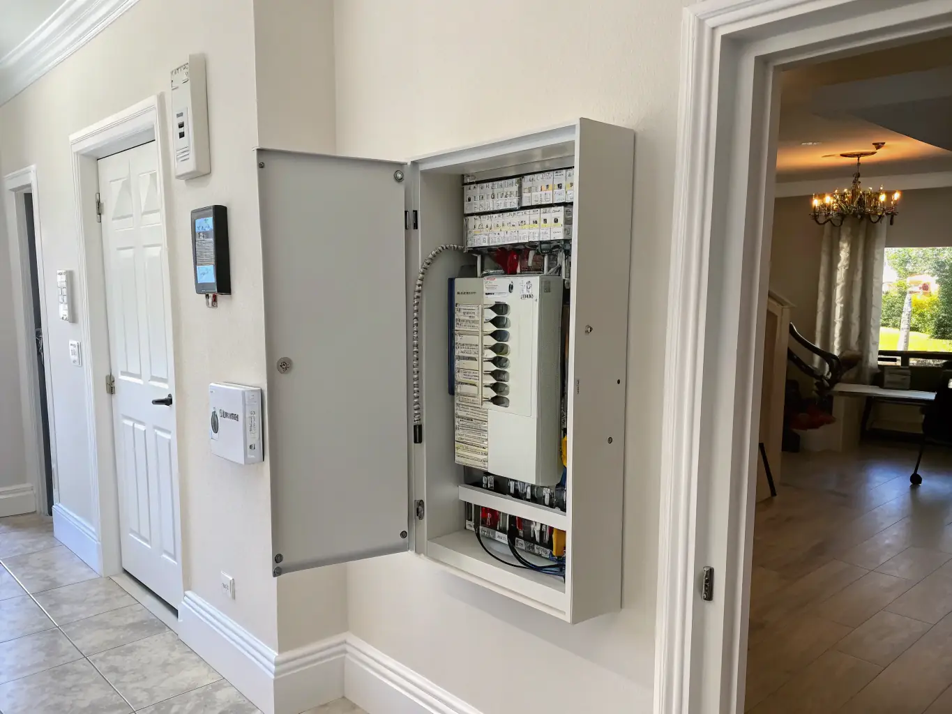 A modern electrical panel being installed in a residential home, showcasing the clean and organized wiring.